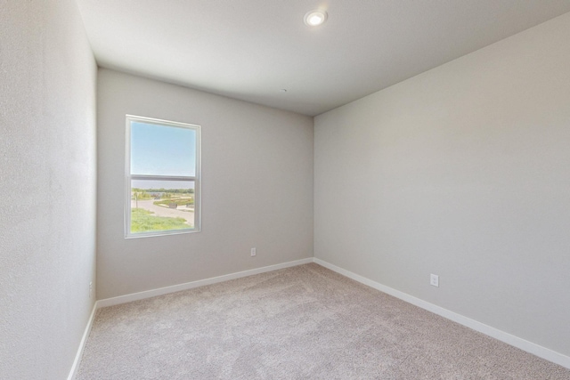 unfurnished room with recessed lighting, carpet flooring, and baseboards