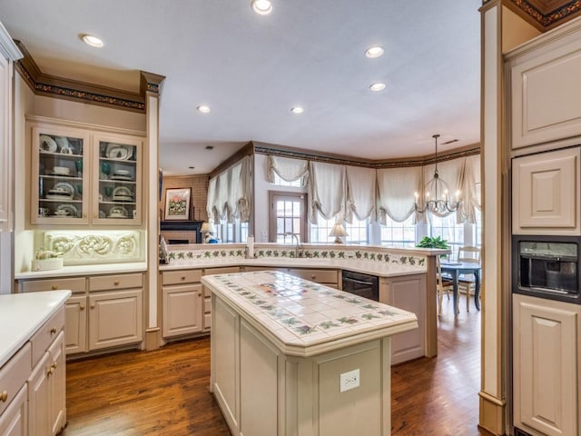 3425 Caleo Ct, Plano, TX 75025 - kitchen with a chandelier, a kitchen island, dark wood-style floors, recessed lighting, and black dishwasher