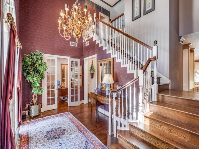 3425 Caleo Ct, Plano, TX 75025 - foyer entrance with a towering ceiling, wood finished floors, french doors, stairway, and a chandelier