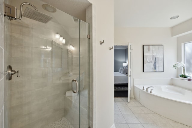 ensuite bathroom featuring tile patterned floors, a stall shower, ensuite bathroom, and a garden tub