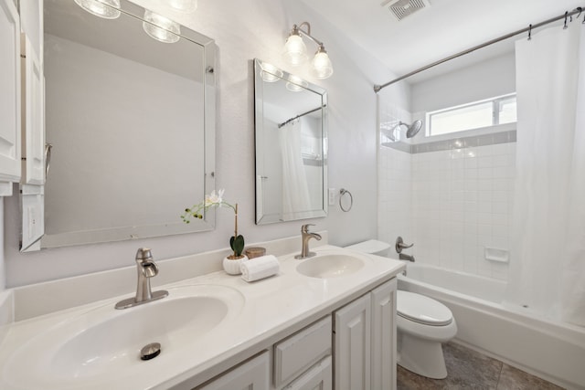 bathroom featuring visible vents, toilet, shower / bath combo, and a sink