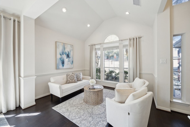 living area with lofted ceiling, recessed lighting, visible vents, and dark wood-type flooring