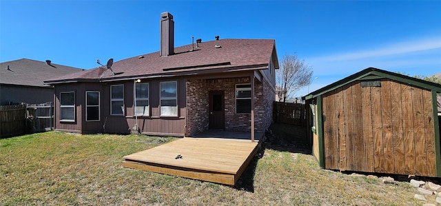 back of house with a lawn, a fenced backyard, brick siding, and a deck