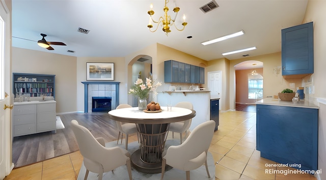 dining area featuring visible vents, arched walkways, and light tile patterned floors
