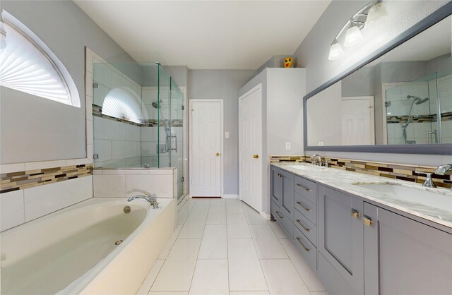 full bathroom featuring double vanity, a sink, a bath, and a stall shower