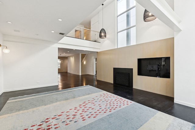 3315 Miro Pl, Dallas, TX 75204 - living room featuring wood finished floors, a fireplace, a towering ceiling, and recessed lighting