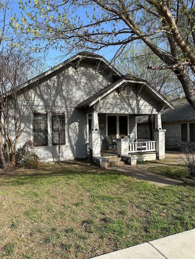 2220 Prospect Ave, Fort Worth, TX 76164 - view of front of home with a front lawn and a porch