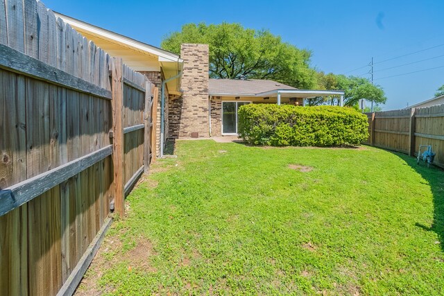 view of yard with a fenced backyard