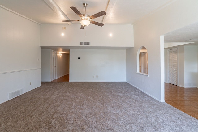 carpeted spare room with high vaulted ceiling, a ceiling fan, and visible vents
