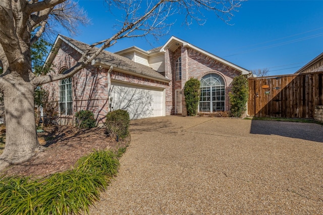 900 Crest Ridge Ct, Irving, TX 75061 - view of front facade featuring brick siding, concrete driveway, an attached garage, and fence