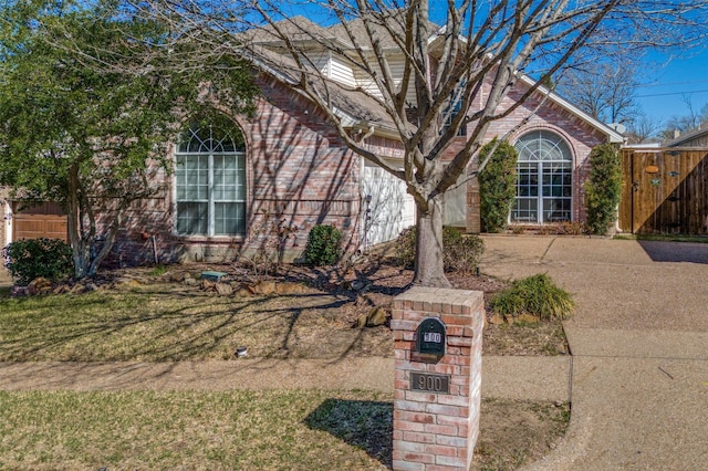 900 Crest Ridge Ct, Irving, TX 75061 - view of property hidden behind natural elements with fence and brick siding