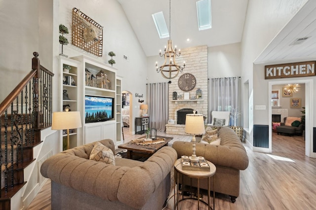 389 Meadow Hill Rd, Fort Worth, TX 76108 - living room featuring a fireplace, high vaulted ceiling, wood finished floors, a chandelier, and a skylight