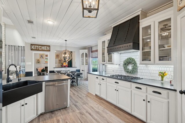 389 Meadow Hill Rd, Fort Worth, TX 76108 - kitchen with appliances with stainless steel finishes, premium range hood, dark countertops, a sink, and a chandelier