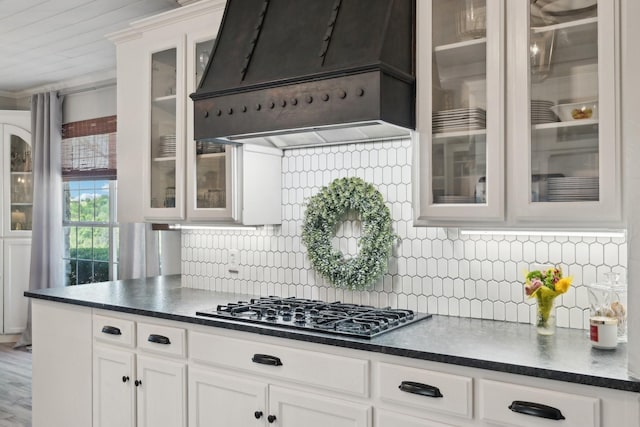 389 Meadow Hill Rd, Fort Worth, TX 76108 - kitchen featuring custom exhaust hood, stainless steel gas cooktop, decorative backsplash, white cabinets, and dark countertops