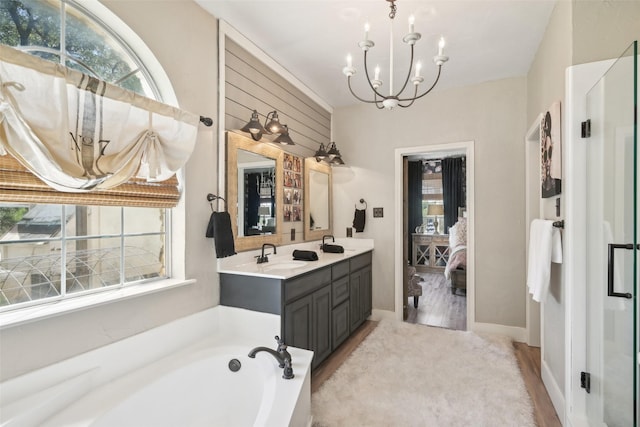 389 Meadow Hill Rd, Fort Worth, TX 76108 - ensuite bathroom with a chandelier, a bath, vanity, and wood finished floors