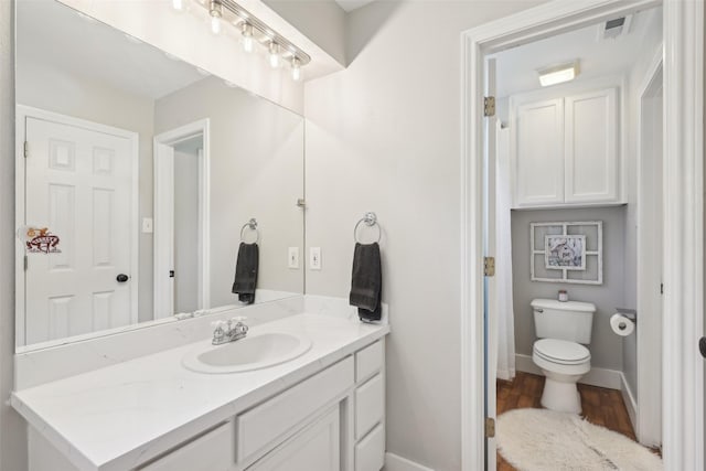389 Meadow Hill Rd, Fort Worth, TX 76108 - bathroom featuring baseboards, vanity, toilet, and wood finished floors