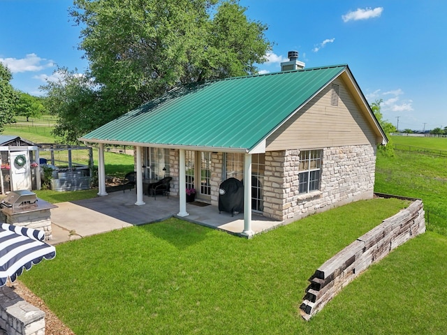 389 Meadow Hill Rd, Fort Worth, TX 76108 - back of property featuring stone siding, a patio area, a lawn, metal roof, and a chimney
