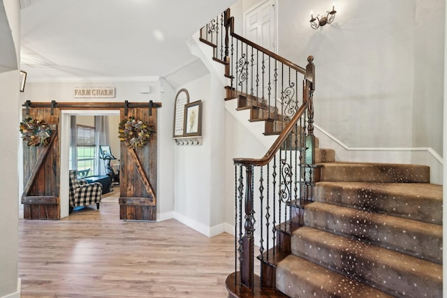 389 Meadow Hill Rd, Fort Worth, TX 76108 - stairs featuring wood finished floors, crown molding, a barn door, and baseboards