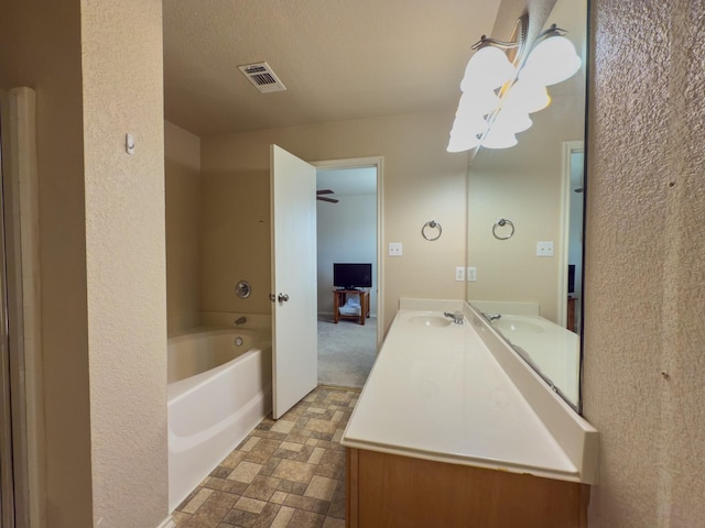 5828 Giddyup Ln, Fort Worth, TX 76179 - full bathroom with double vanity, a bath, visible vents, and a sink