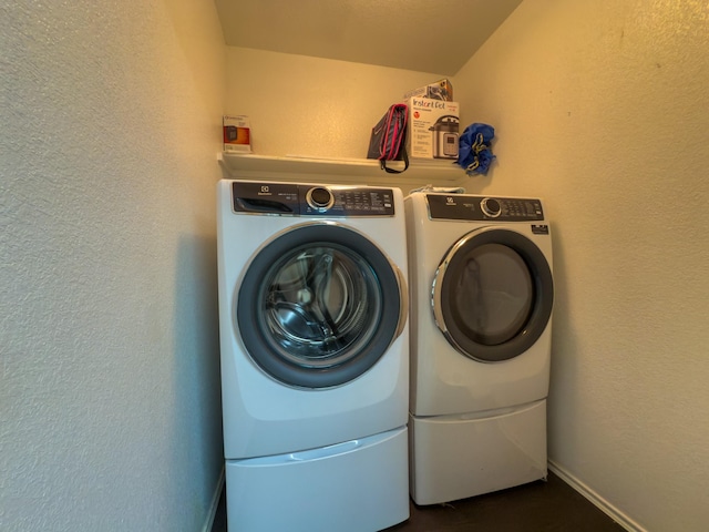 5828 Giddyup Ln, Fort Worth, TX 76179 - laundry room with laundry area, a textured wall, baseboards, and washing machine and clothes dryer