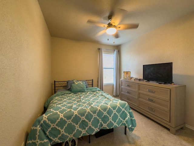 5828 Giddyup Ln, Fort Worth, TX 76179 - bedroom with light carpet, a ceiling fan, and a textured wall