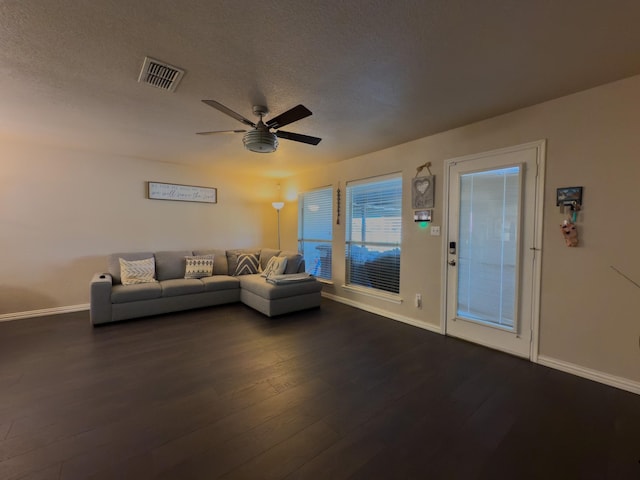 5828 Giddyup Ln, Fort Worth, TX 76179 - living room featuring visible vents, dark wood-type flooring, a ceiling fan, a textured ceiling, and baseboards