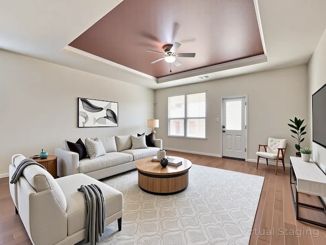 2232 Heaton St, Forney, TX 75126 - living room featuring a tray ceiling, a ceiling fan, wood finished floors, and baseboards