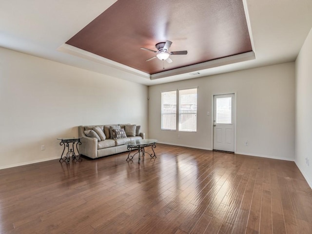 2232 Heaton St, Forney, TX 75126 - living room with a tray ceiling, a ceiling fan, baseboards, and wood finished floors