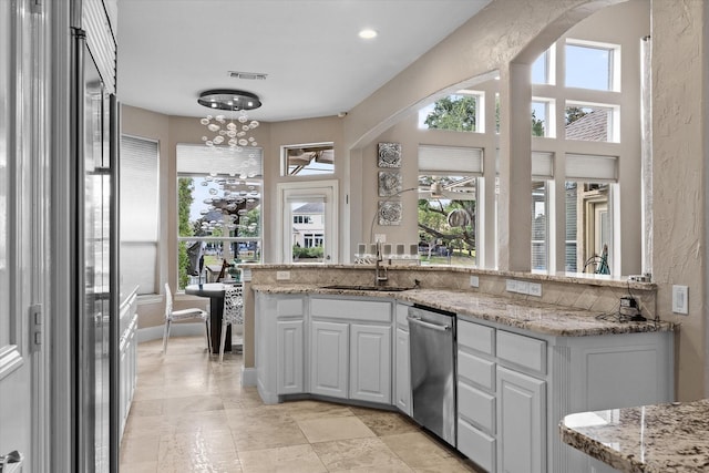 4648 Venetian Way, Frisco, TX 75034 - kitchen featuring a sink, dishwasher, healthy amount of natural light, arched walkways, and recessed lighting