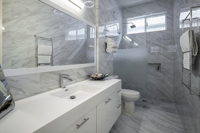 4648 Venetian Way, Frisco, TX 75034 - bathroom with tile walls, marble finish floors, a shower stall, toilet, and vanity