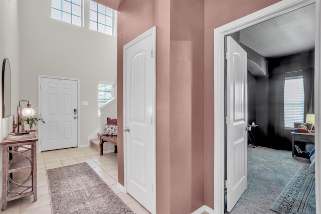 1380 Levi Ln, Forney, TX 75126 - entrance foyer featuring light tile patterned flooring, stairway, baseboards, and a towering ceiling