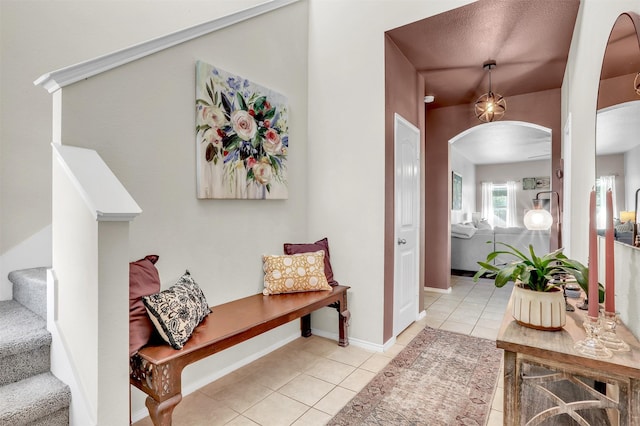 1380 Levi Ln, Forney, TX 75126 - corridor featuring arched walkways, stairway, baseboards, and light tile patterned flooring