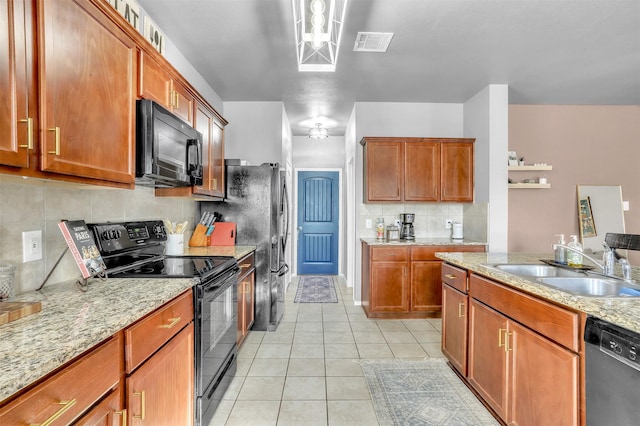 1380 Levi Ln, Forney, TX 75126 - kitchen with visible vents, light tile patterned floors, brown cabinetry, black appliances, and a sink
