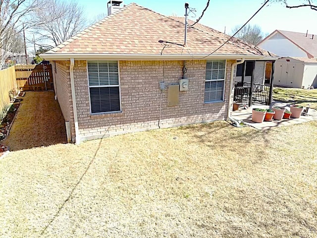 510 Canary Ln, Red Oak, TX 75154 - back of house with brick siding, roof with shingles, a chimney, and a fenced backyard