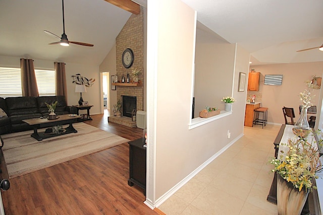 510 Canary Ln, Red Oak, TX 75154 - living room with a ceiling fan, a brick fireplace, baseboards, high vaulted ceiling, and light wood finished floors