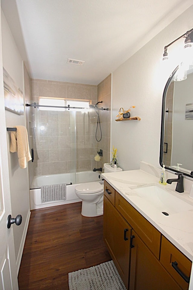510 Canary Ln, Red Oak, TX 75154 - full bath with wood finished floors, toilet, washtub / shower combination, and vanity