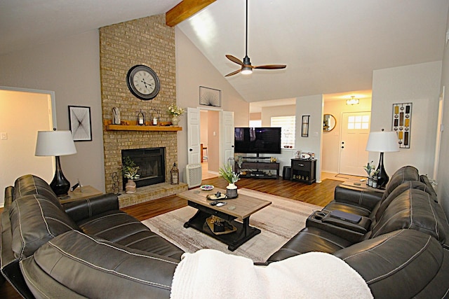 510 Canary Ln, Red Oak, TX 75154 - living room with wood finished floors, a ceiling fan, high vaulted ceiling, beamed ceiling, and a brick fireplace