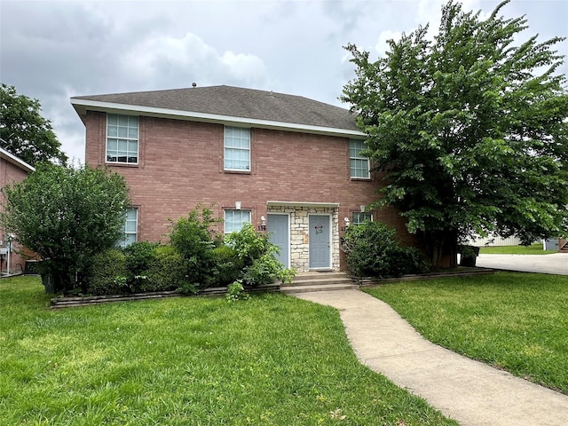 112-114 S Holly Ave, Sherman, TX 75092 - colonial house featuring brick siding and a front lawn