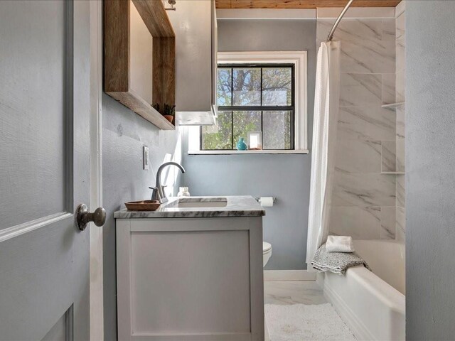 1402 Murphy Ave, Lufkin, TX 75904 - bathroom featuring marble finish floors, vanity, toilet, shower / bath combo, and baseboards