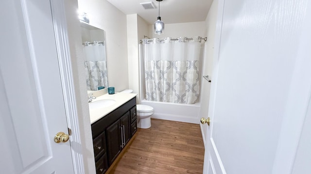 full bathroom featuring visible vents, toilet, wood finished floors, vanity, and shower / bathtub combination with curtain
