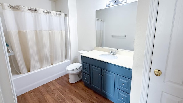 bathroom with toilet, shower / tub combo, wood finished floors, and vanity
