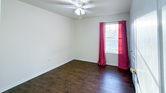 empty room with baseboards, ceiling fan, and wood finished floors