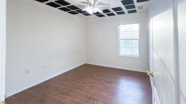 empty room featuring baseboards, visible vents, wood finished floors, and a ceiling fan