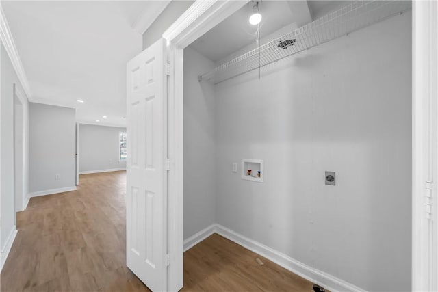 washroom with hookup for a washing machine, wood finished floors, baseboards, and electric dryer hookup