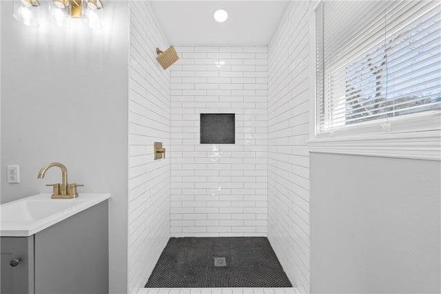 bathroom featuring vanity and a tile shower