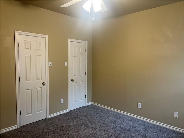 unfurnished room with baseboards, dark colored carpet, and ceiling fan