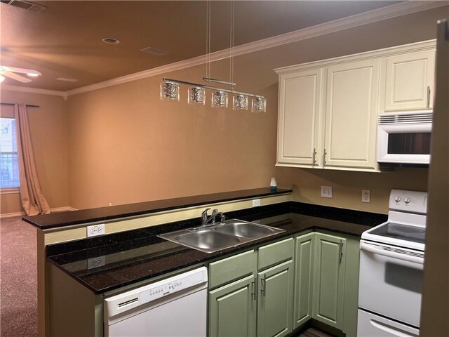 kitchen featuring ornamental molding, a peninsula, white cabinets, white appliances, and a sink