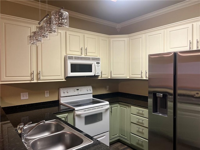 kitchen with dark countertops, ornamental molding, white appliances, and a sink