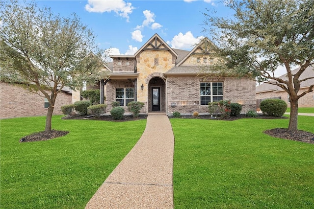 2313 Therese Dr, Waco, TX 76712 - view of front of home featuring a front lawn, brick siding, and stone siding