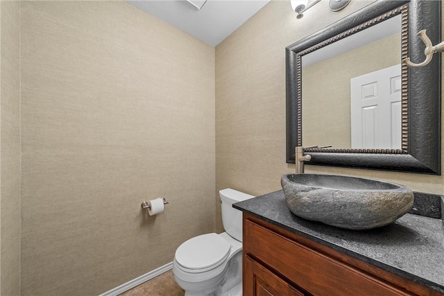 125 Pleasant Grove Ln, Waco, TX 76712 - bathroom featuring toilet, vanity, and baseboards
